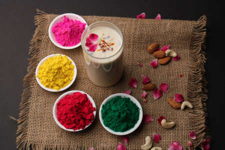 Indian festival Holi concept - Traditional Indian beverage Thandai Sardai milk festival food, with nuts and color in bowl.の写真素材