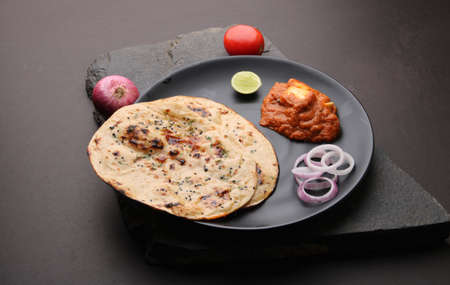 Paneer Butter Masala or Cheese Cottage Curry  served with naan or tandoori roti.の写真素材