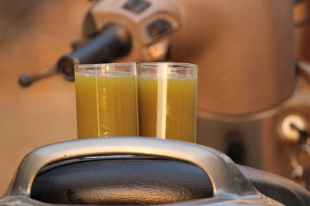 Sugarcane juice in glass with piece of sugarcane, lemon and black saltの写真素材