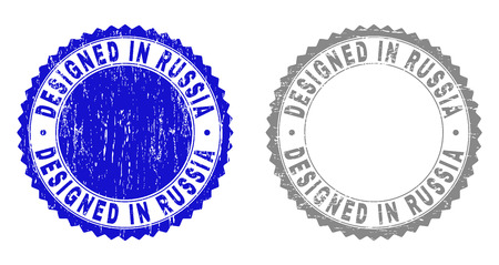 Grunge DESIGNED IN RUSSIA stamp seals isolated on a white background. Rosette seals with grunge texture in blue and grey colors.のイラスト素材