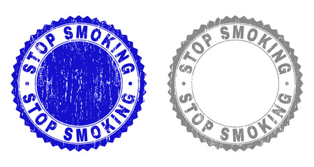 Grunge STOP SMOKING stamp seals isolated on a white background. Rosette seals with grunge texture in blue and gray colors. Vector rubber watermark of STOP SMOKING label inside round rosette.のイラスト素材