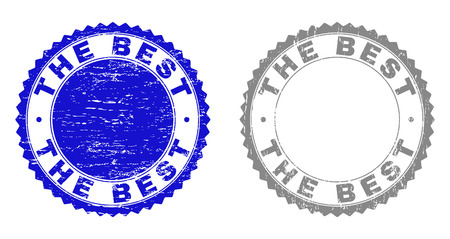 Grunge THE BEST stamp seals isolated on a white background. Rosette seals with grunge texture in blue and gray colors. Vector rubber stamp imitation of THE BEST caption inside round rosette.のイラスト素材