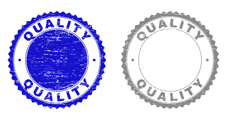 Grunge QUALITY stamp seals isolated on a white background. Rosette seals with grunge texture in blue and gray colors. Vector rubber stamp imitation of QUALITY label inside round rosette.のイラスト素材