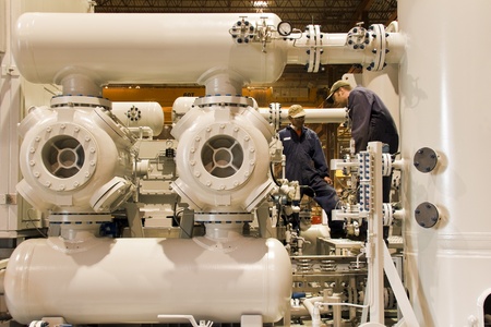 Natural gas compressor station  with two working techniciansの写真素材