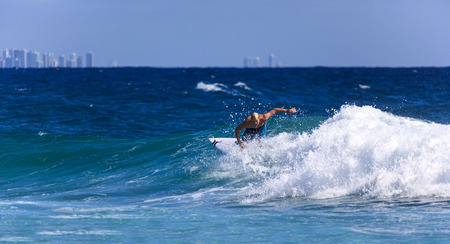 SNAPPER ROCKS, GOLD COAST, AUSTRALIA - 5 MARCH  Unidentified Surfer races the Quiksilver   Roxy Pro World Title Event  9 March 2014, Snapper Rocks, Gold Coast, Australia のeditorial素材