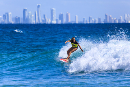 SNAPPER ROCKS, GOLD COAST, AUSTRALIA - 5 MARCH  Unidentified Surfer races the Quiksilver   Roxy Pro World Title Event  5 March 2014, Snapper Rocks, Gold Coast, Australia のeditorial素材