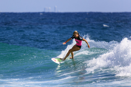 SNAPPER ROCKS, GOLD COAST, AUSTRALIA - 5 MARCH  Unidentified Surfer races the Quiksilver   Roxy Pro World Title Event  5 March 2014, Snapper Rocks, Gold Coast, Australia のeditorial素材