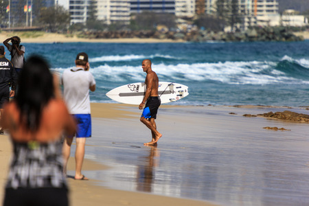 SNAPPER ROCKS, GOLD COAST, AUSTRALIA - 5 MARCH  Unidentified Surfer races the Quiksilver   Roxy Pro World Title Event  5 March 2014, Snapper Rocks, Gold Coast, Australia のeditorial素材