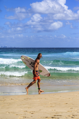 SNAPPER ROCKS, GOLD COAST, AUSTRALIA - 5 MARCH  Unidentified Surfer races the Quiksilver   Roxy Pro World Title Event  5 March 2014, Snapper Rocks, Gold Coast, Australia のeditorial素材