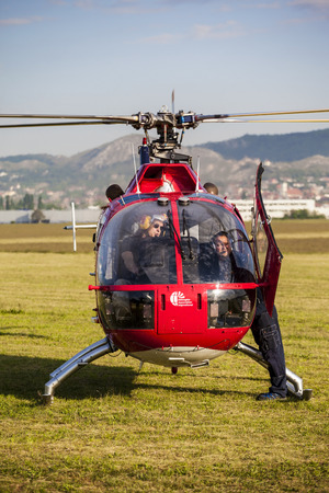 BUDAPEST HUNGARY - MAY 3: A Red Bull aerobatic helicopter demonstrates different flying techniques, for civilian as well as some air force personnel on May 1 2014 Hungary.のeditorial素材