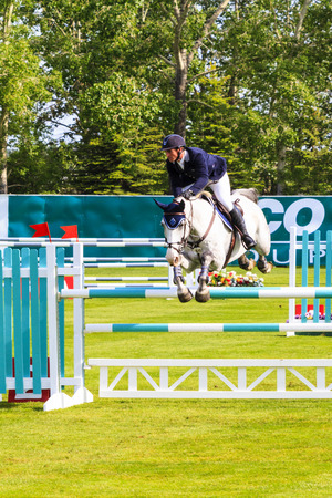 CALGARY CANADA - JUN 7 2015: Unidentified rider in action during the prestige's Spruce Meadows International hors jumping competition,  riders comes all over the world to compete.のeditorial素材