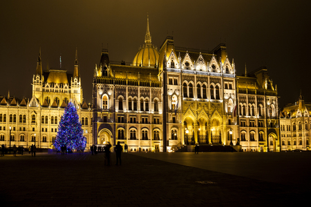BUDAPEST, HUNGARY - DEC 19 2015: Tourists enjoy the Christmas lights at the Parliament House in Budapest, Hungary. This traditional Christmas fair attracts abut 700,000 visitors each year.のeditorial素材
