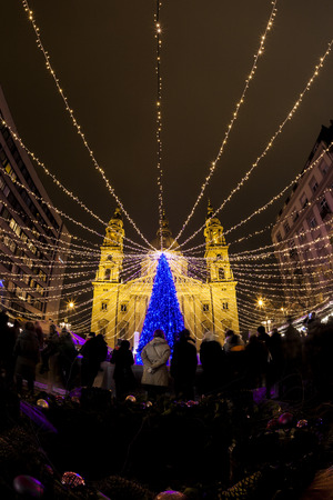 BUDAPEST, HUNGARY - DEC 19 2015: Tourists enjoy the Christmas lights at the St Steven Basilica in Budapest, Hungary. This traditional Christmas fair attracts abut 700,000 visitors each year.のeditorial素材