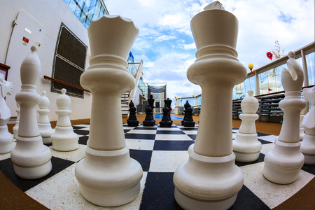 ON BOARD OF CRUISE SHIP N.C.L. DAWN JAN 26 2016: Chessboard and chess pieces on the deckのeditorial素材