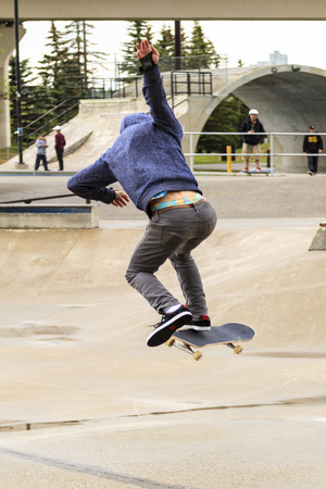 CALGARY, CANADA - JUN 21, 2015: Athletes have a friendly skateboard Show Off in Calgary. California law requires anyone under the age of 18 to wear a helmet while riding a skateboard.のeditorial素材
