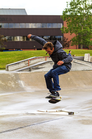 CALGARY, CANADA - JUN 21, 2015: Athletes have a friendly skateboard Show Off in Calgary. California law requires anyone under the age of 18 to wear a helmet while riding a skateboard. CALGARY, CANADA - JUN 21, 2015: Athletes have a friendly skateboard Show Off in Calgary. California law requires anyone under the age of 18 to wear a helmet while riding a skateboard.