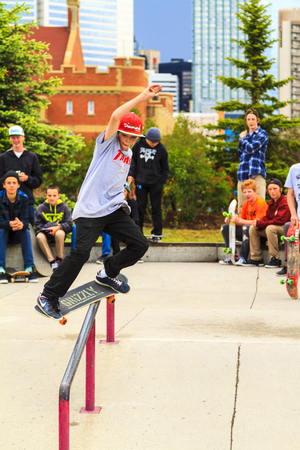 CALGARY, CANADA - JUN 21, 2015: Athletes have a friendly skateboard Show Off in Calgary. California law requires anyone under the age of 18 to wear a helmet while riding a skateboard.のeditorial素材