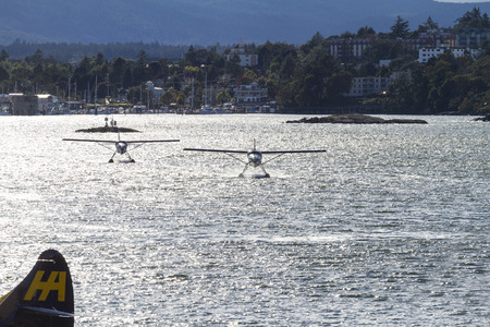 :   VICTORIA, BC, CANADA - JULY 26 2016: Harbor Air Float-plane in the inner harbor. This...