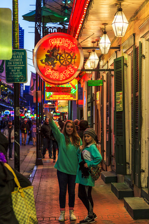 NEW ORLEANS, LOUISIANA USA- JAN 23 2016: Pubs and Bars having colorful lights and decorations in the French Quarter. Tourism provides a much needed financial source, also home for great musicians.のeditorial素材