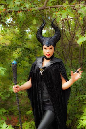 Calgary Canada - Sept 01, 2014: Illustrative cosplayer dressed up as witch with horns. Demonic, dark with red lips. Evil and beautiful.のeditorial素材