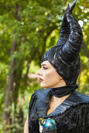 Calgary Canada - Sept 01, 2014: Illustrative cosplayer dressed up as witch with horns. Demonic, dark with red lips. Evil and beautiful.のeditorial素材