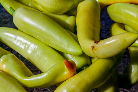 A backdrop of stacked yellow peppersの写真素材