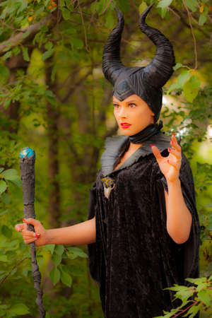 Calgary Canada - Sept 01, 2014: Illustrative cosplayer dressed up as witch with horns. Demonic, dark with red lips. Evil and beautiful.のeditorial素材
