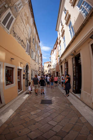 Zadar, Croatia 09 17 2019: Narrow streets, public squares and people of old town of Zadar. Historical buildings and souvenir shops.のeditorial素材