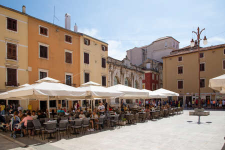 Zadar, Croatia 09 17 2019: Narrow streets, public squares and people of old town of Zadar. Historical buildings and souvenir shops.のeditorial素材