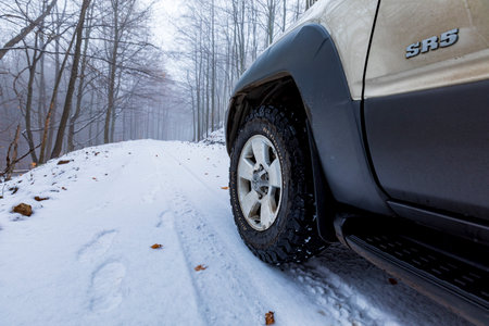 KÃ©kes  Hungary Dec.  27, 2020: An off-road vehicle Toyota 4Runner in the foggy snow covered...