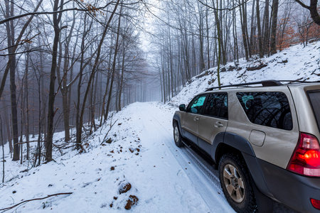 KÃ©kes  Hungary Dec.  27, 2020: An off-road vehicle Toyota 4Runner in the foggy snow covered...