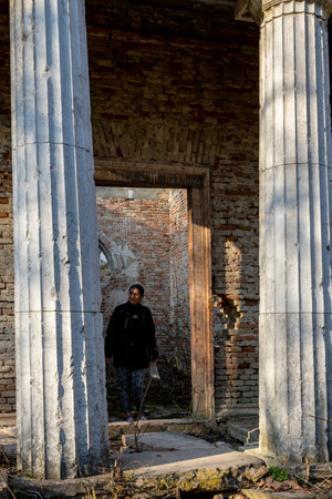 Hungary Bicske Mar. 2, 2022: Unidentified lady at a ruins in the countryside in the forest.のeditorial素材