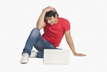 Man sitting in front of a laptopの写真素材