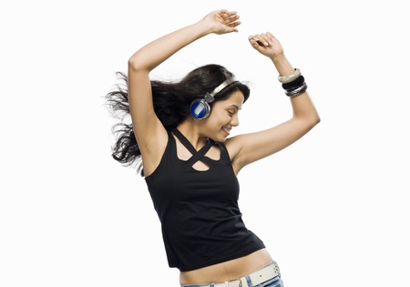 Young woman listening to music and dancingの写真素材