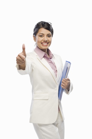 Portrait of a businesswoman showing thumbs upの写真素材