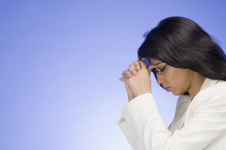 Frustrated businesswoman with her head in her handsの写真素材