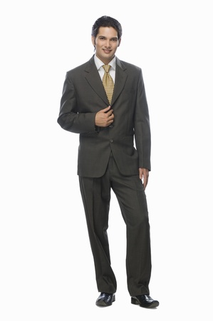 Portrait of a businessman standing against a white backgroundの写真素材