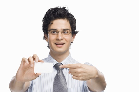 Portrait of a businessman showing a blank business cardの写真素材