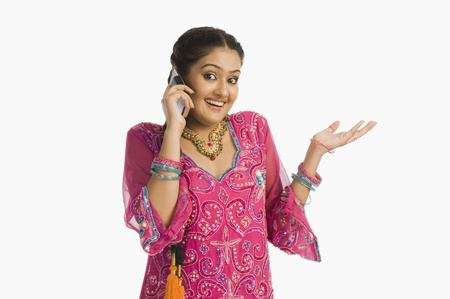 Woman wearing a salwar kameez and talking on a mobile phone