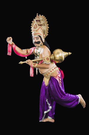 Portrait of a stage artist running in Ravana costume