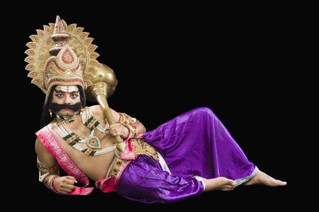 Portrait of a man dressed-up as Ravana the Hindu mythological character and holding a maceの写真素材