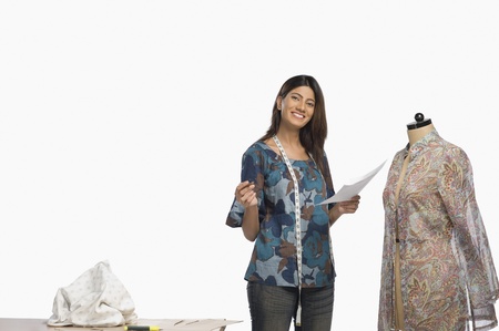 Female fashion designer sketching a dress