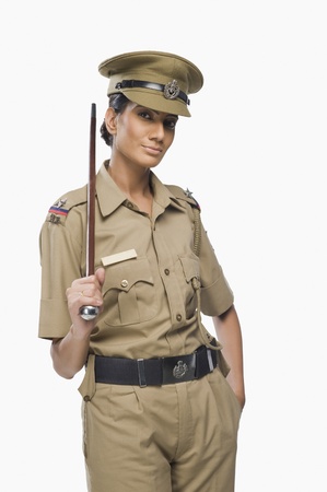 Portrait of a female police officer holding a stick