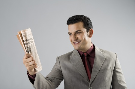 Businessman holding a newspaperの写真素材