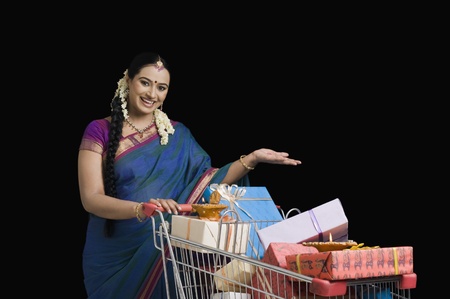 Woman carrying Diwali gifts in a shopping cartの写真素材