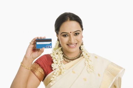 Woman showing a credit card and smiling