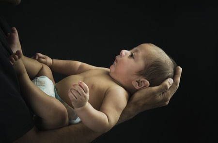 Man carrying his son in arms