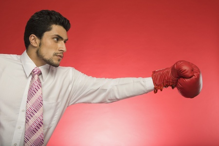 Businessman wearing boxing gloveの写真素材