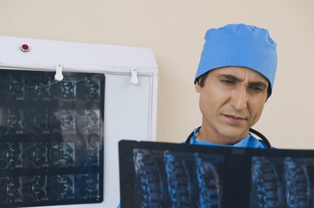 Surgeon examining an x-ray reportの写真素材