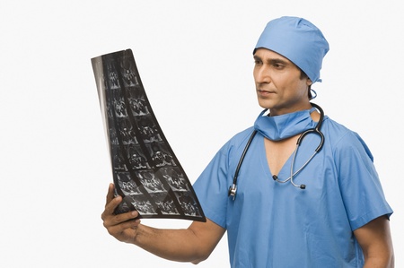 Surgeon examining an x-ray report